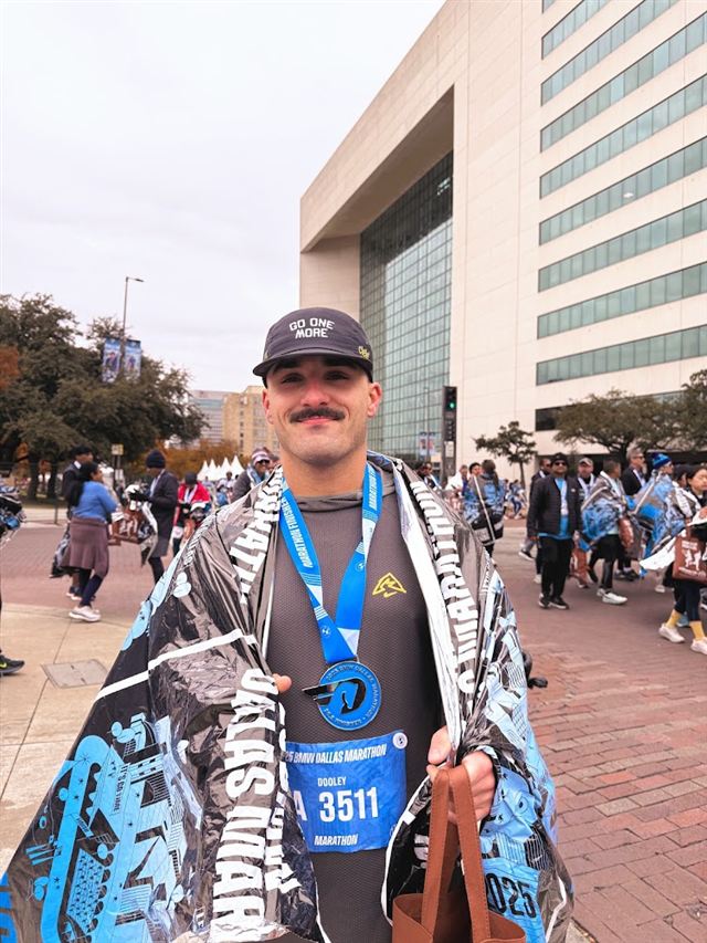 Hunter at the finish of the BMW Dallas Marathon with his medal